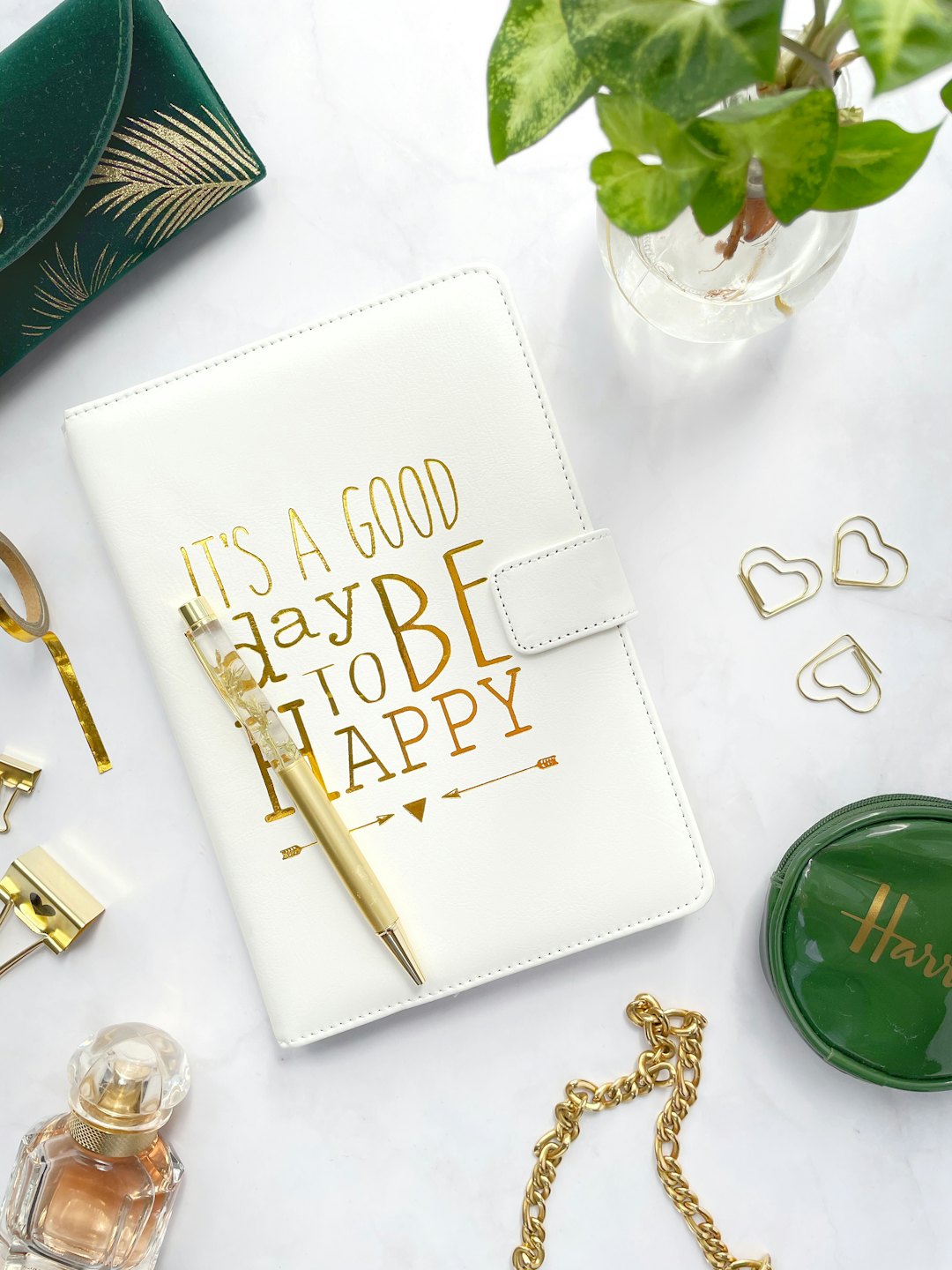 Stylish desk accessories arranged neatly on a white marble surface.